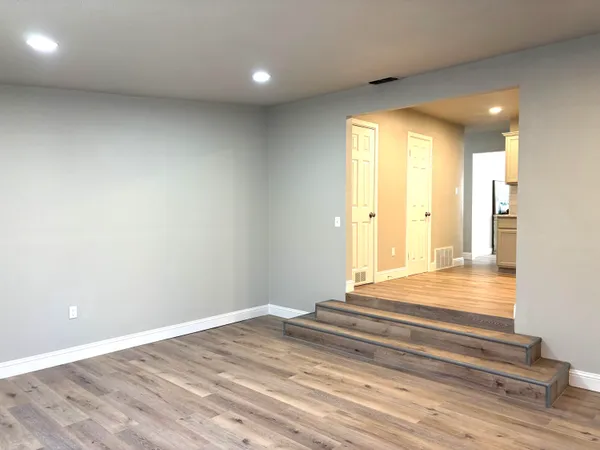 a kitchen with stainless steel appliances granite countertop a stove a sink and a microwave
