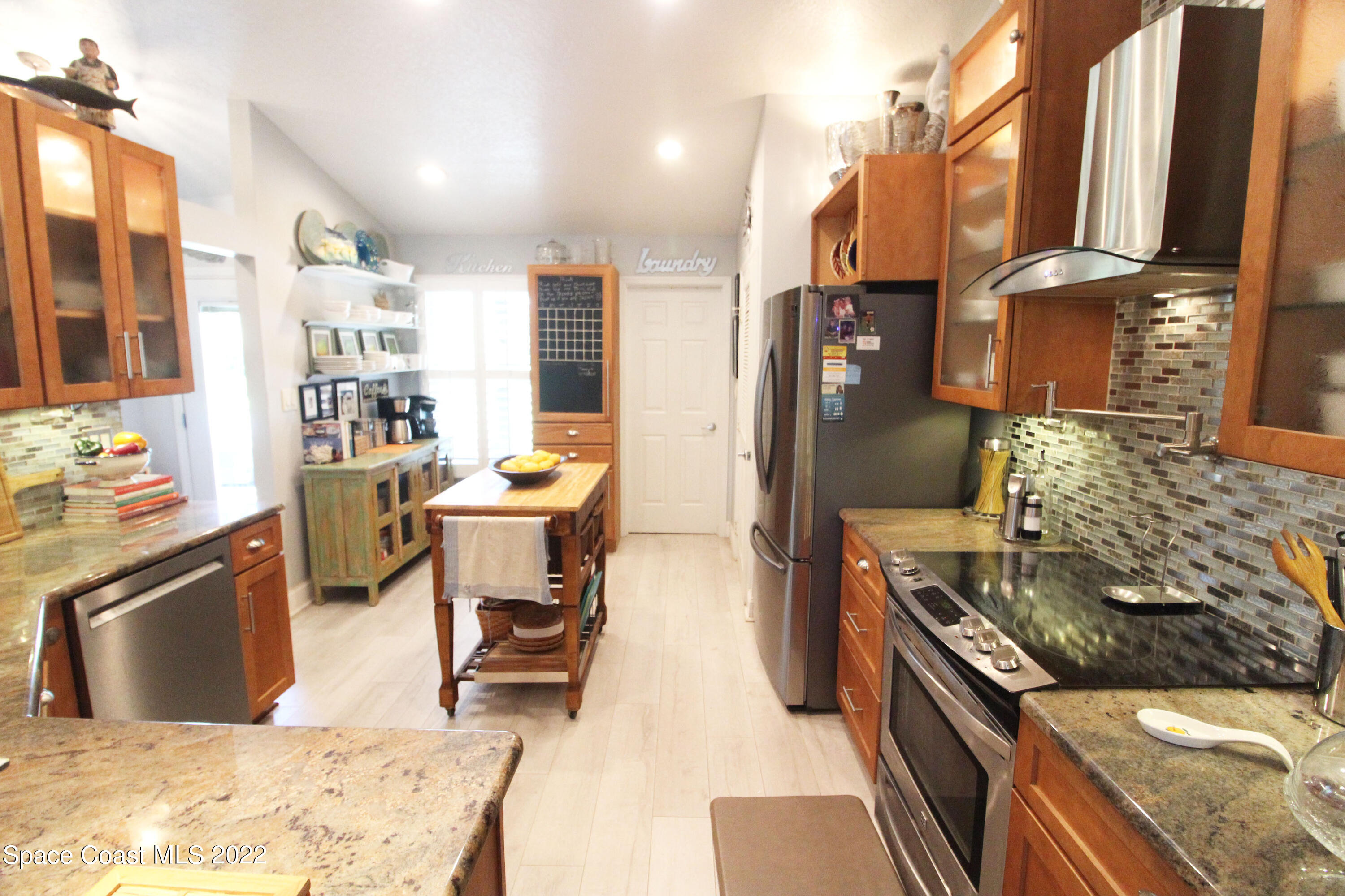 2397 Chase Hammock Road Merritt Island, FL 32953 - Photo 17 of 35 a kitchen with a stove and a refrigerator