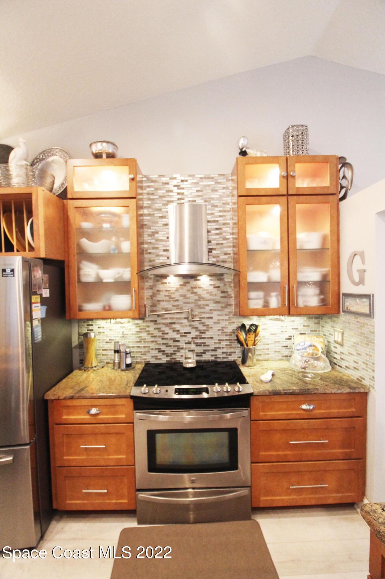 2397 Chase Hammock Road Merritt Island, FL 32953 - Photo 19 of 35 a kitchen with granite countertop a stove and a microwave