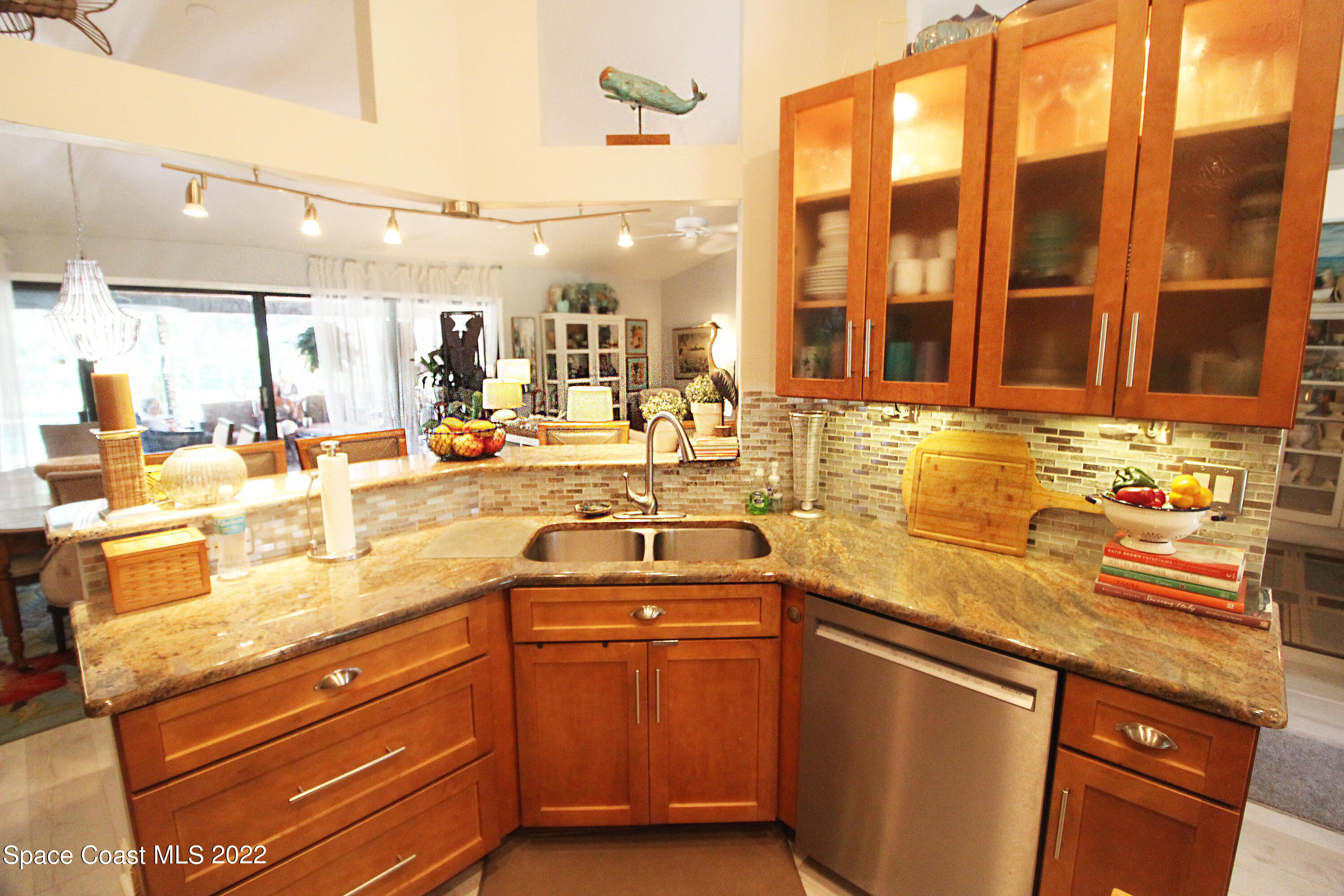 2397 Chase Hammock Road Merritt Island, FL 32953 - Photo 21 of 35 a kitchen with stainless steel appliances granite countertop a sink stove and cabinets