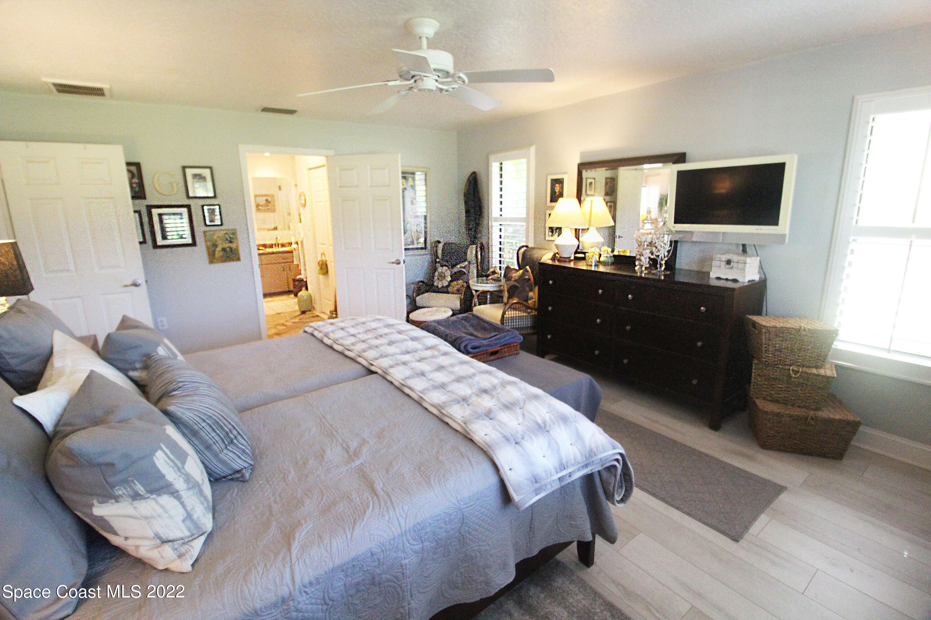 2397 Chase Hammock Road Merritt Island, FL 32953 - Photo 25 of 35 a bedroom with a bed and a flat screen tv