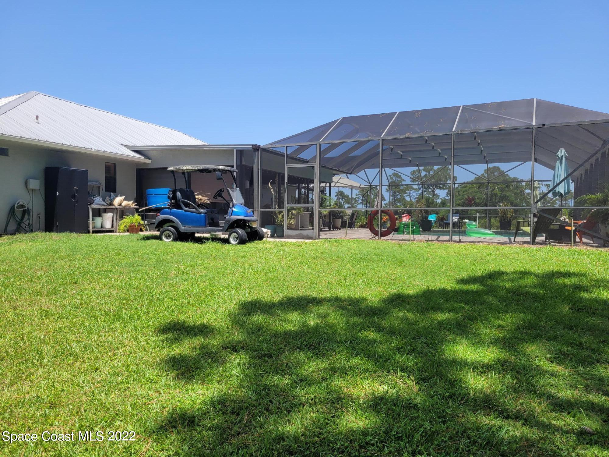 2397 Chase Hammock Road Merritt Island, FL 32953 - Photo 3 of 35 a view of a house with backyard porch and sitting area