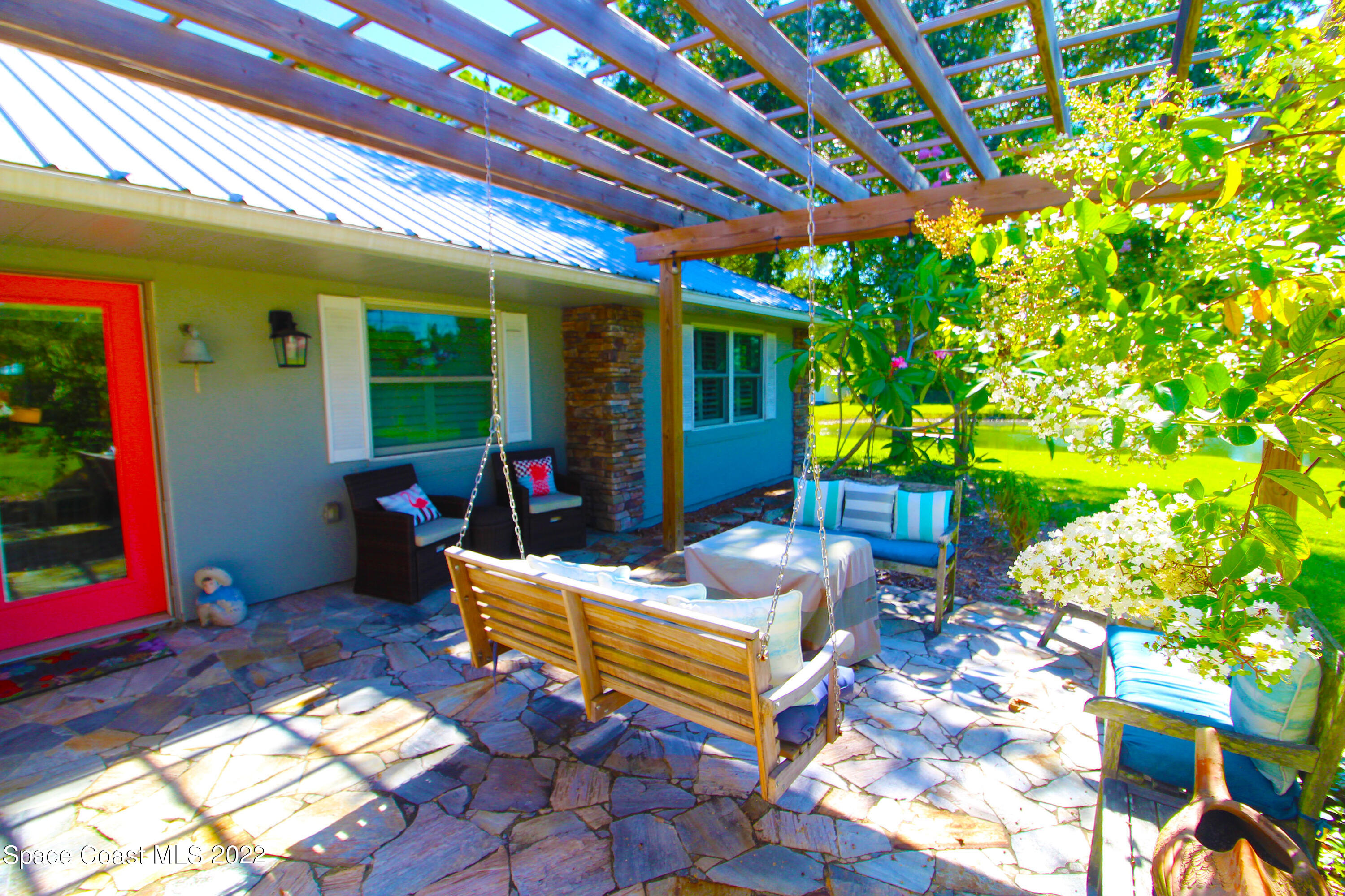 2397 Chase Hammock Road Merritt Island, FL 32953 - Photo 6 of 35 a backyard of a house with fountain table and chairs