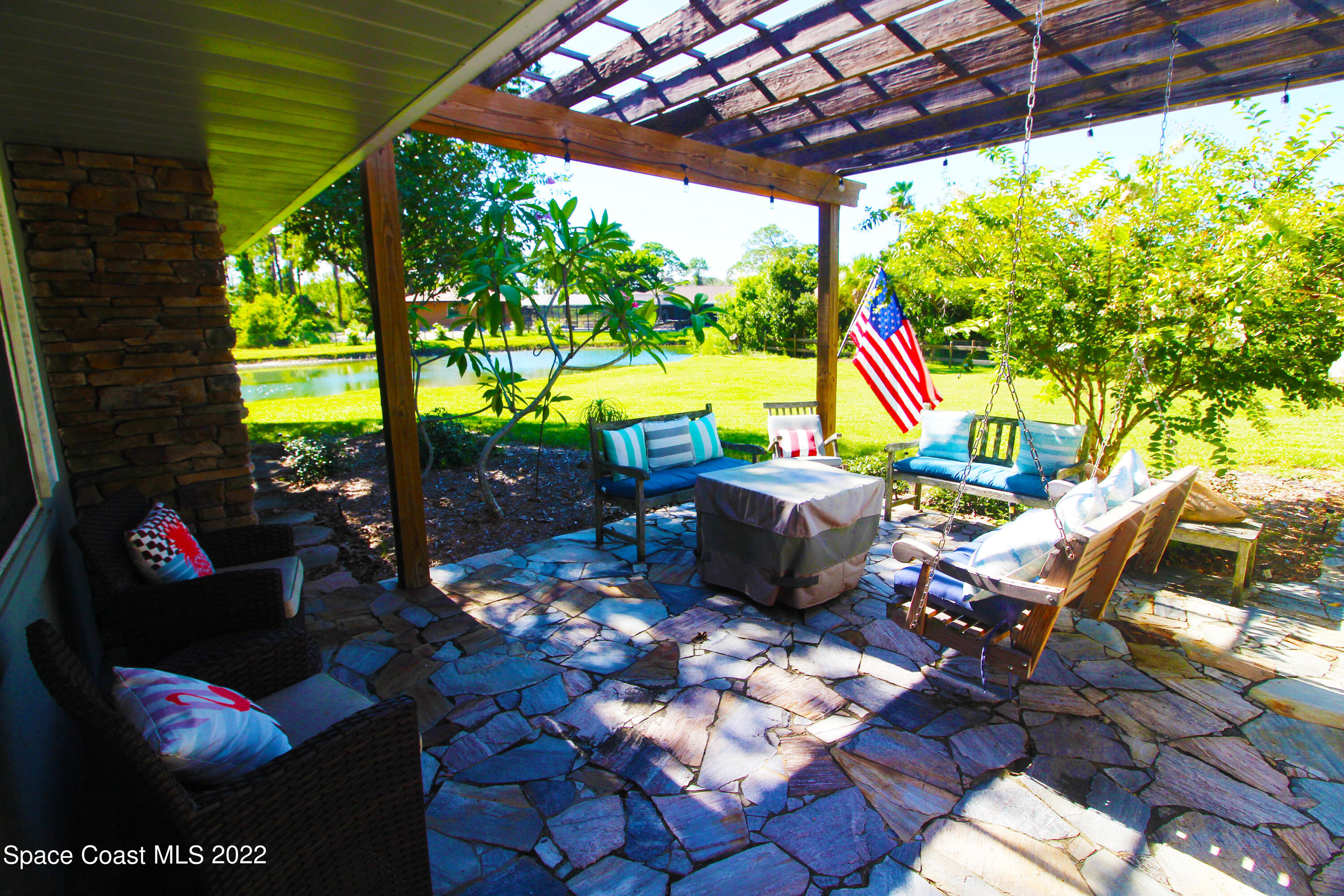 2397 Chase Hammock Road Merritt Island, FL 32953 - Photo 7 of 35 a view of yard from deck with patio