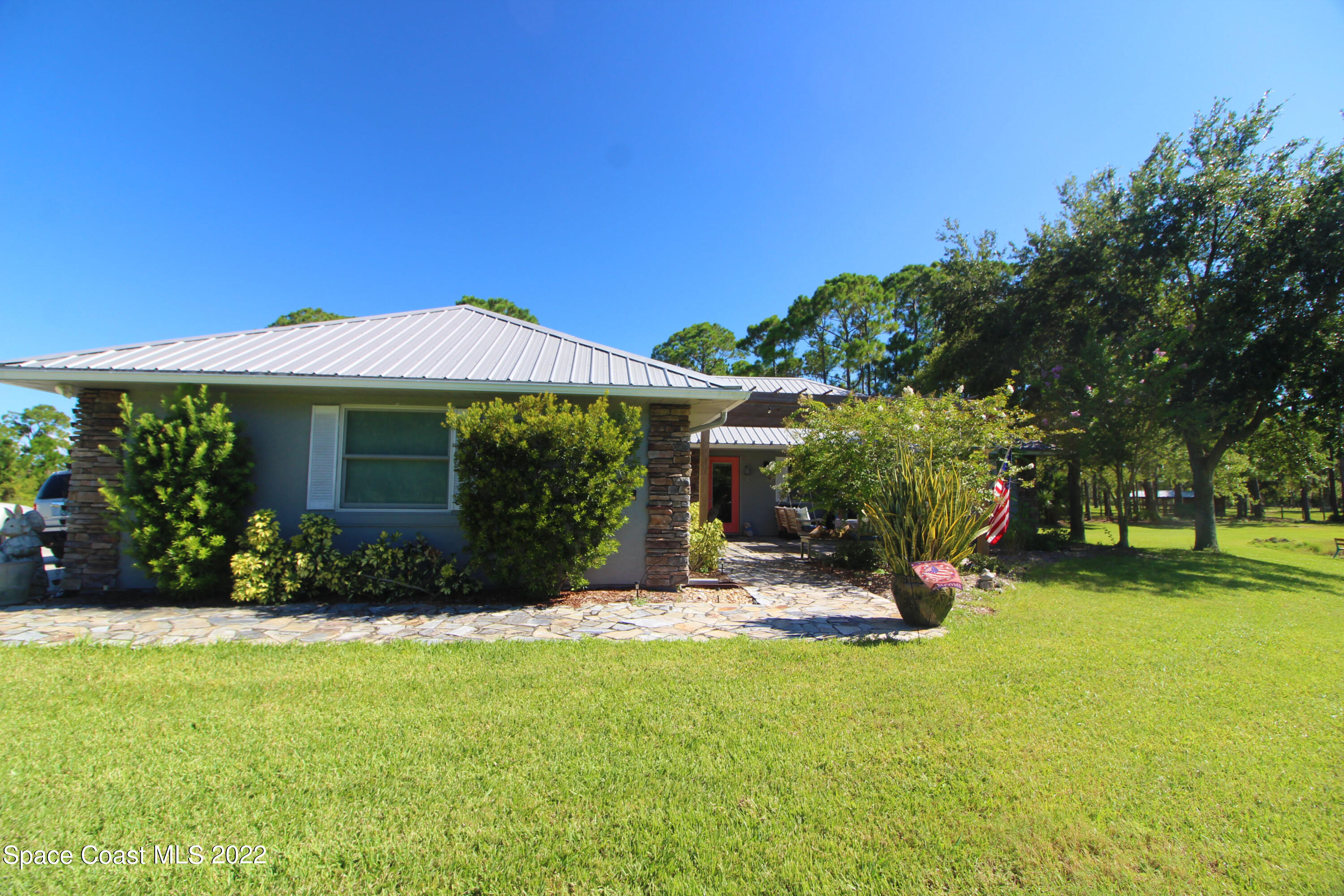 2397 Chase Hammock Road Merritt Island, FL 32953 - Photo 9 of 35 a front view of a house with garden