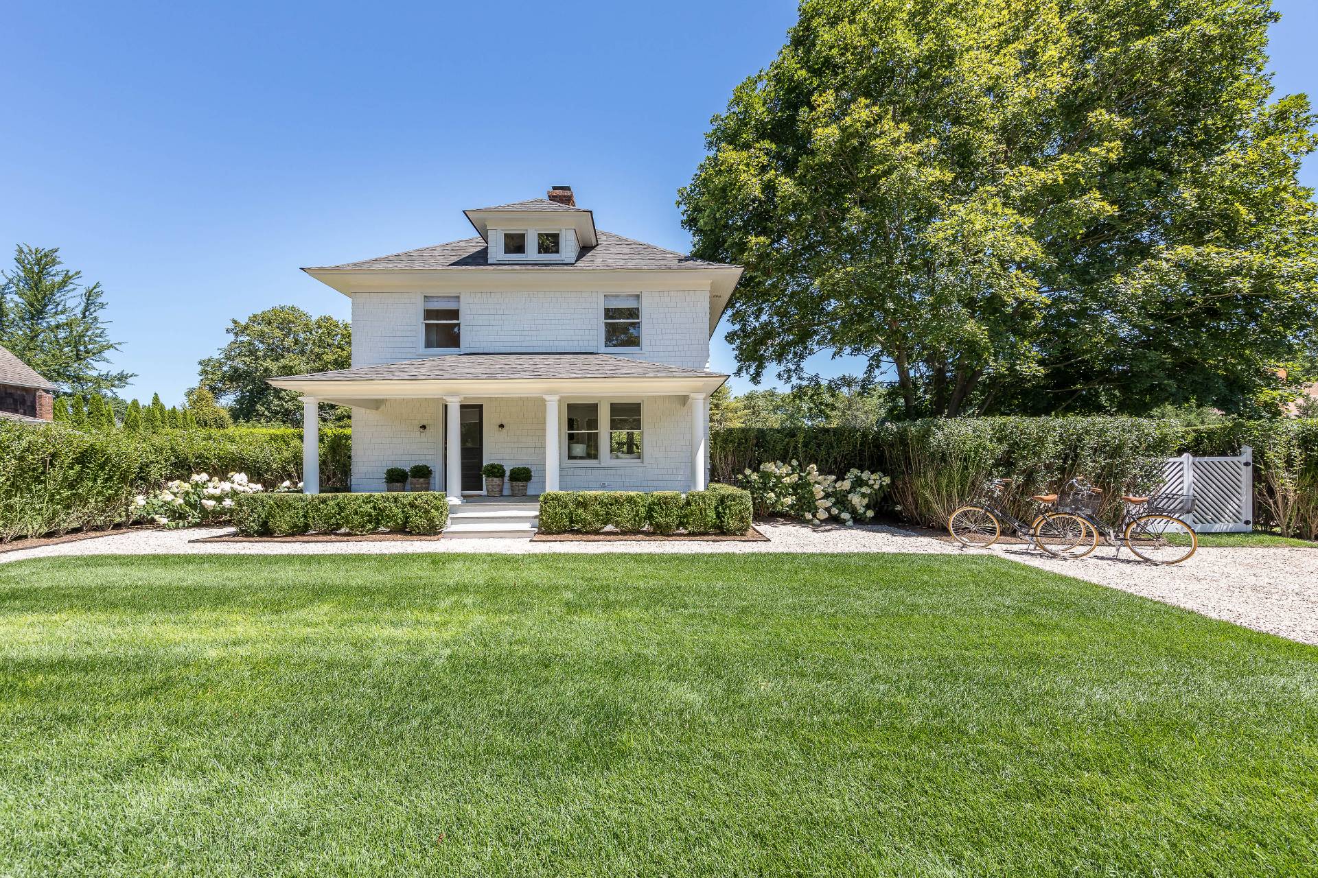 a front view of a house with a garden