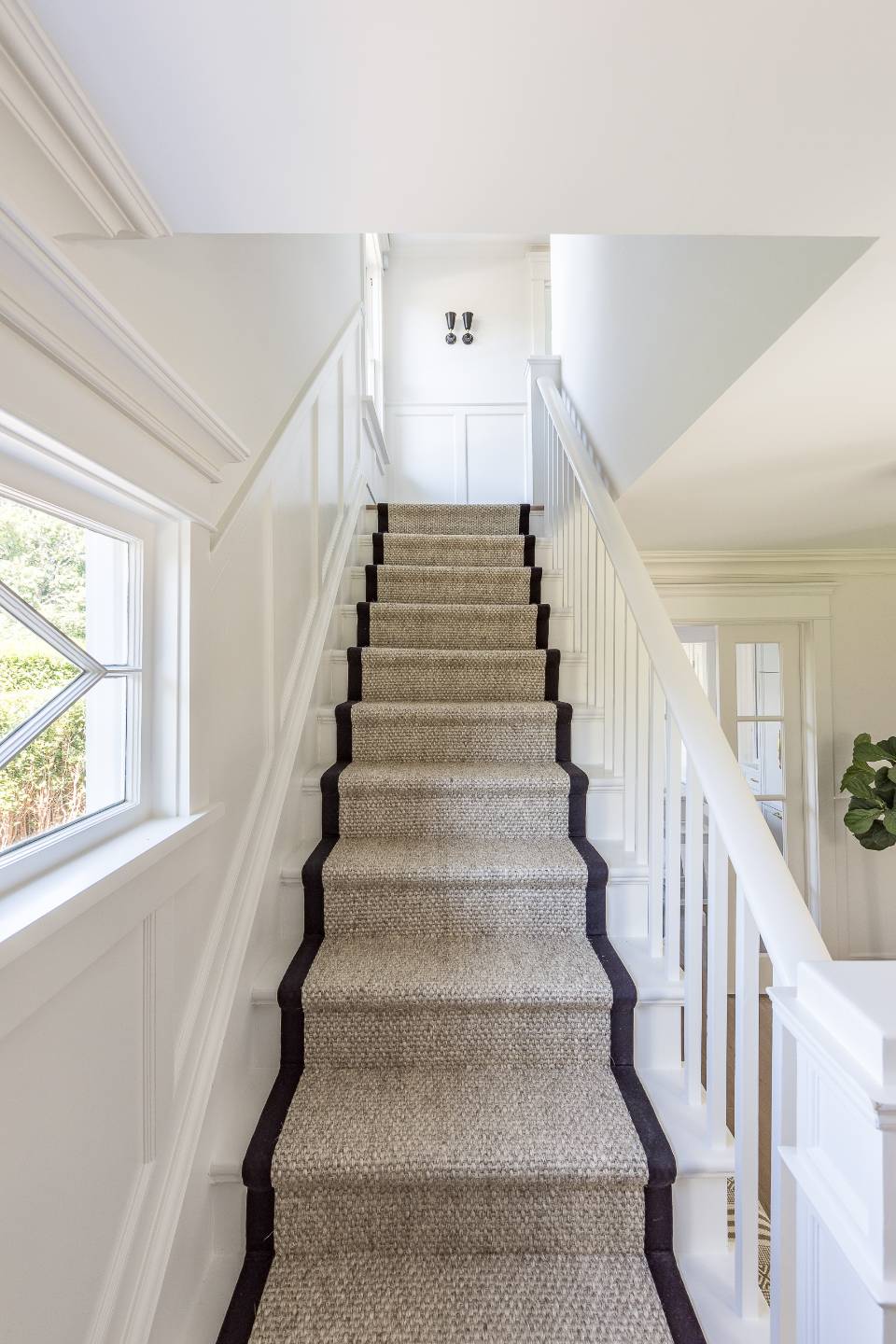 67 Norris Lane Bridgehampton, NY 11937 - Photo 16 of 32 a view of staircase with lots of frames on wall and a window