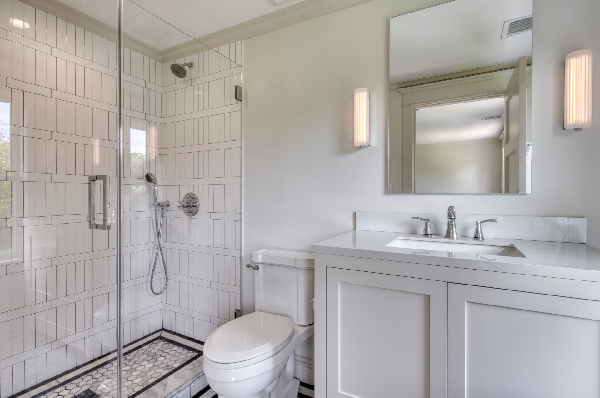 67 Norris Lane Bridgehampton, NY 11937 - Photo 19 of 32 a bathroom with a granite countertop sink toilet a mirror and shower