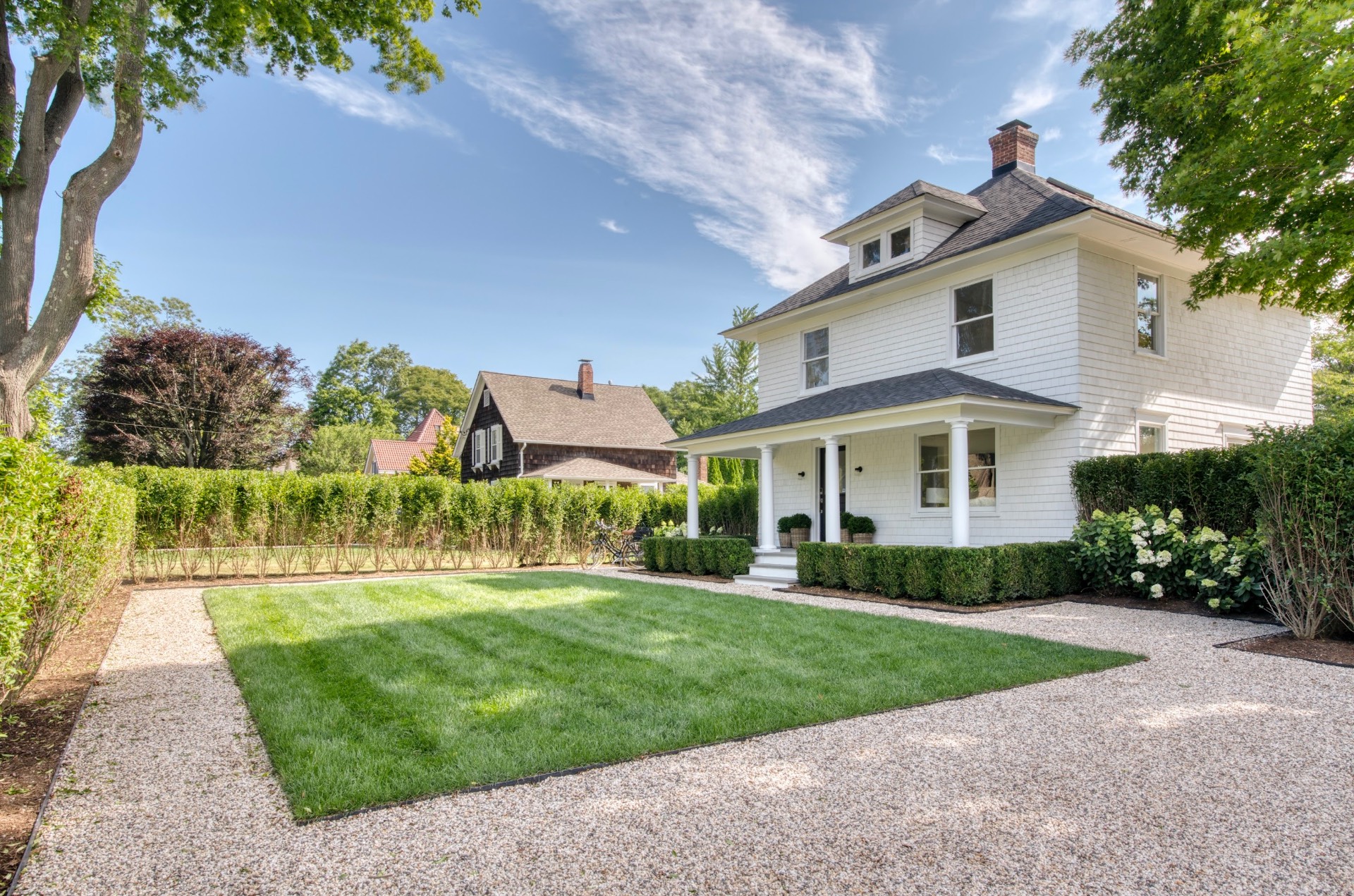 67 Norris Lane Bridgehampton, NY 11937 - Photo 2 of 32 a front view of a house with a yard and potted plants
