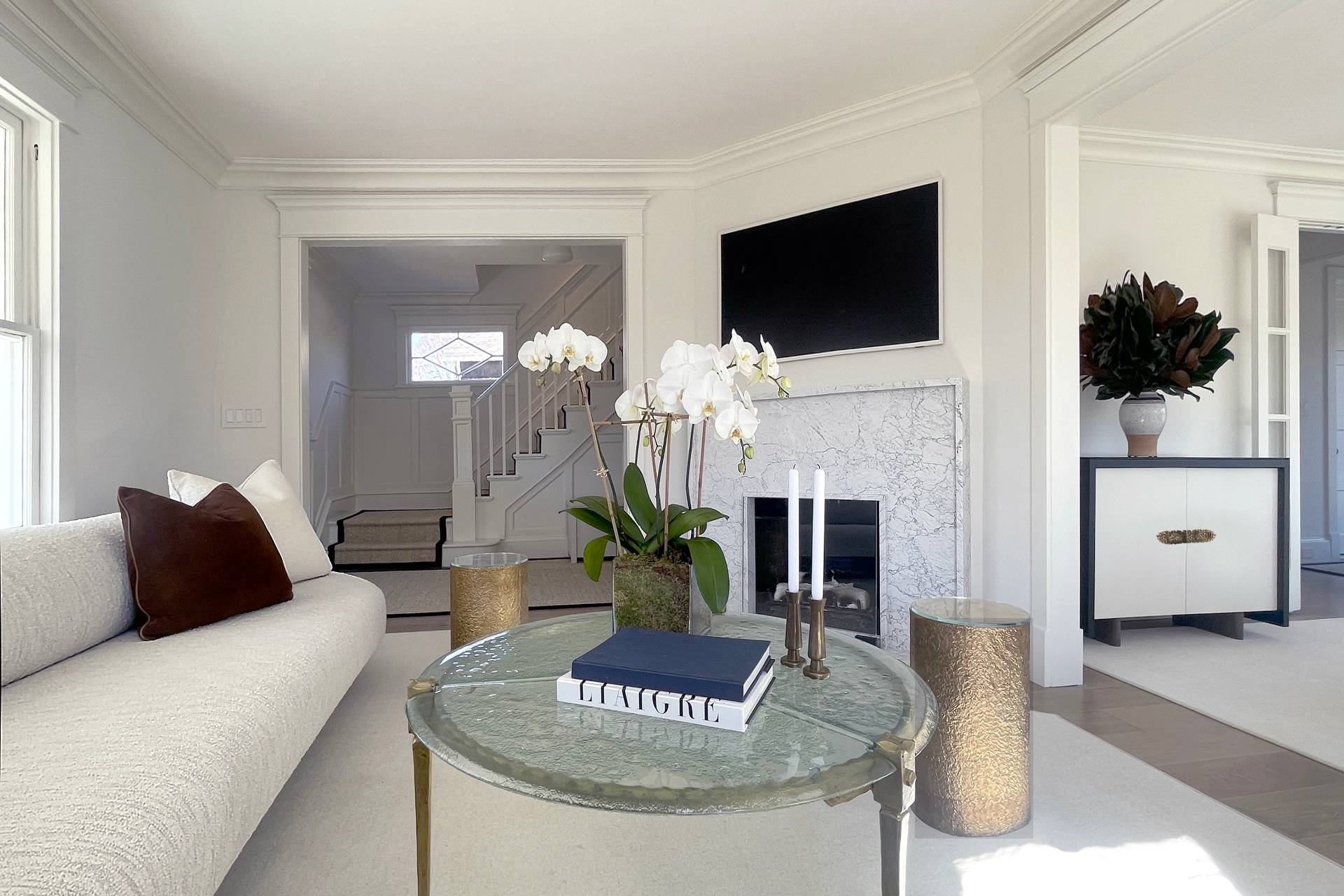 67 Norris Lane Bridgehampton, NY 11937 - Photo 9 of 32 a living room with furniture a flat screen tv and a fireplace