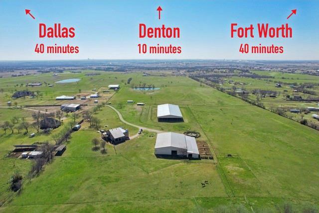6501 Trietsch Road Sanger, TX 76266 - Photo 1 of 39 Country living SO close to the cities! Looking south, you see the home on the left, the shop with apartment and stable on the right, and the 100 x 200 covered arena just above the shop and stable. (Grass is virtually enhanced.)