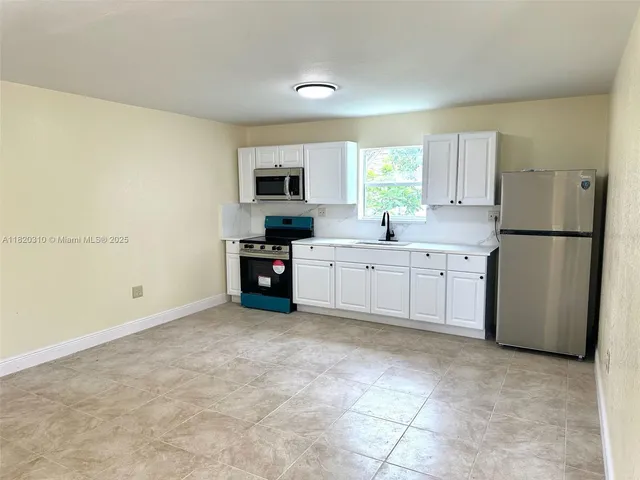 a view of a kitchen with electric appliances