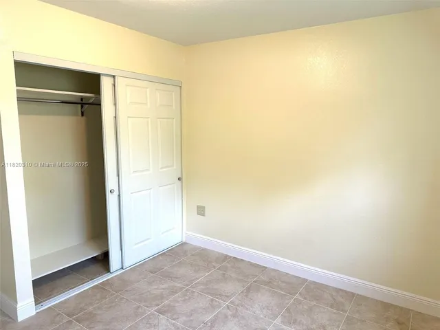 an empty room with a wooden door