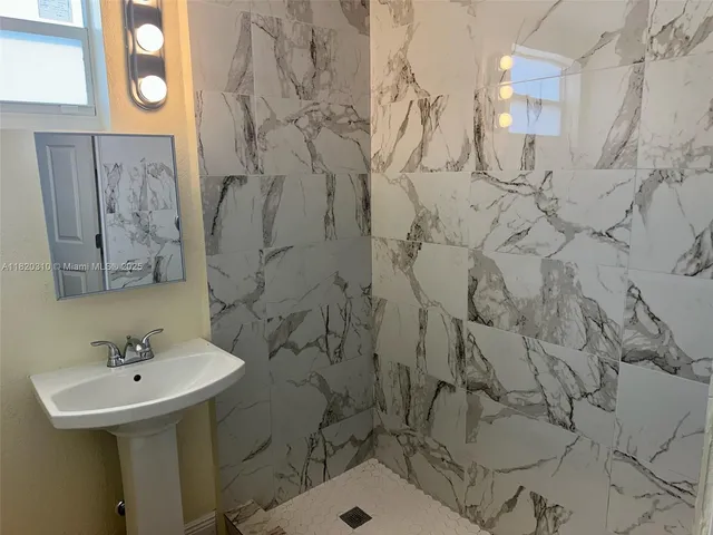 a bathroom with a sink toilet and mirror