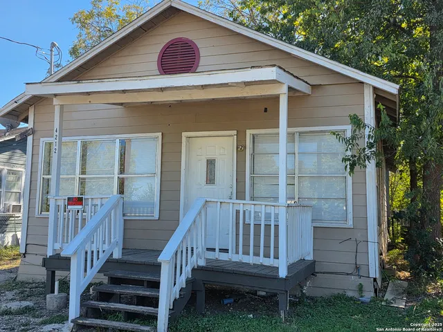 a view of a house with wooden deck and a yard