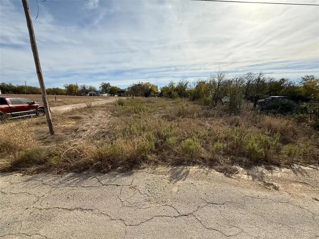 a view of a field with trees