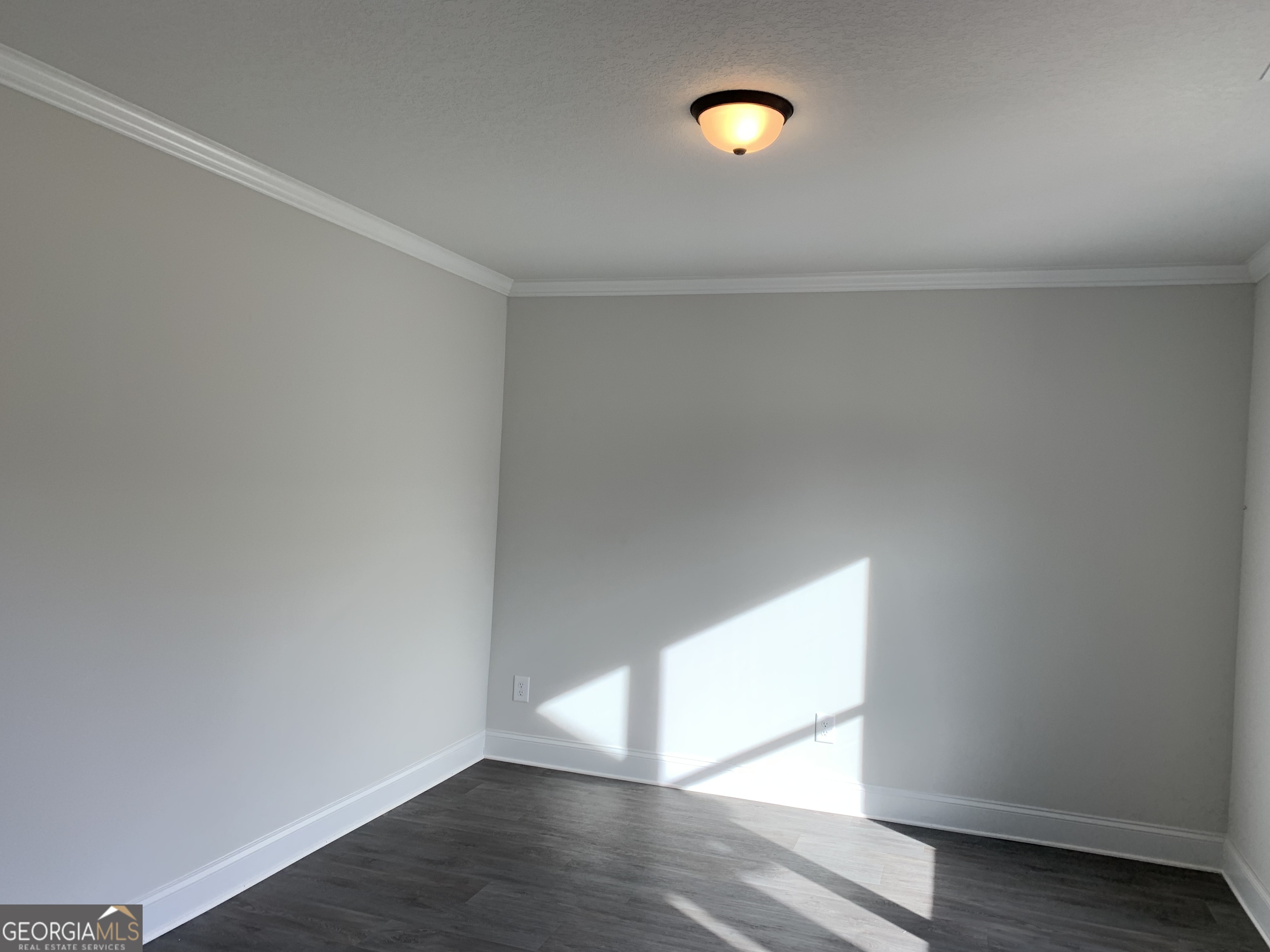 457 Riley Circle Northwest Milledgeville, GA 31061 - Photo 11 of 16 a view of empty room with wooden floor and fan