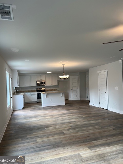 457 Riley Circle Northwest Milledgeville, GA 31061 - Photo 4 of 16 a view of kitchen with kitchen island microwave and cabinets