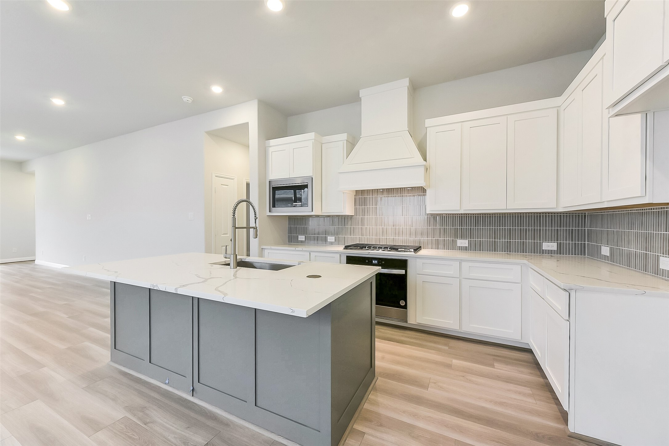 16323 Placid Stream Street Conroe, TX 77302 - Photo 12 of 36 a kitchen with a sink stove and cabinets