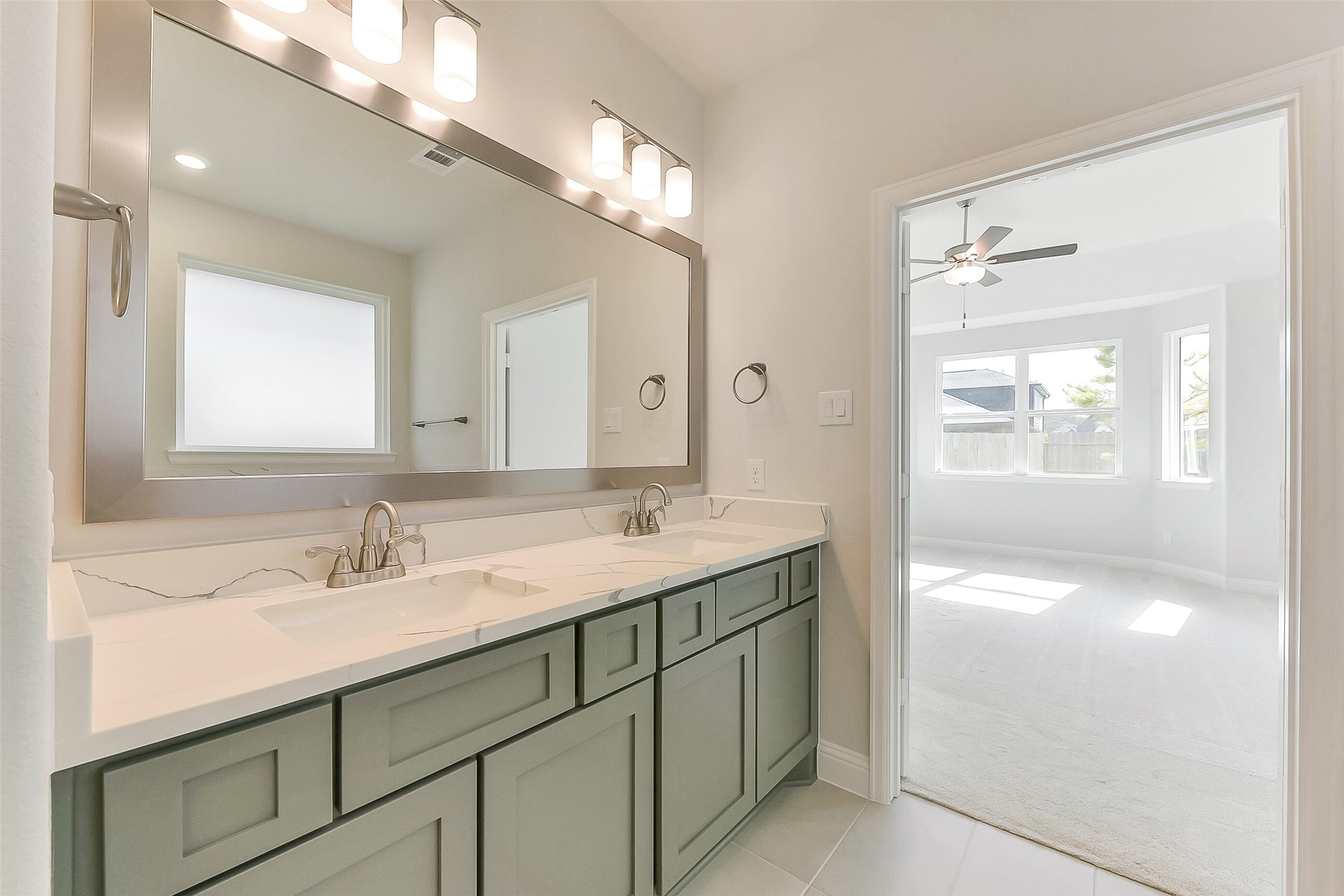 16323 Placid Stream Street Conroe, TX 77302 - Photo 22 of 36 a bathroom with a sink double vanity and a mirror