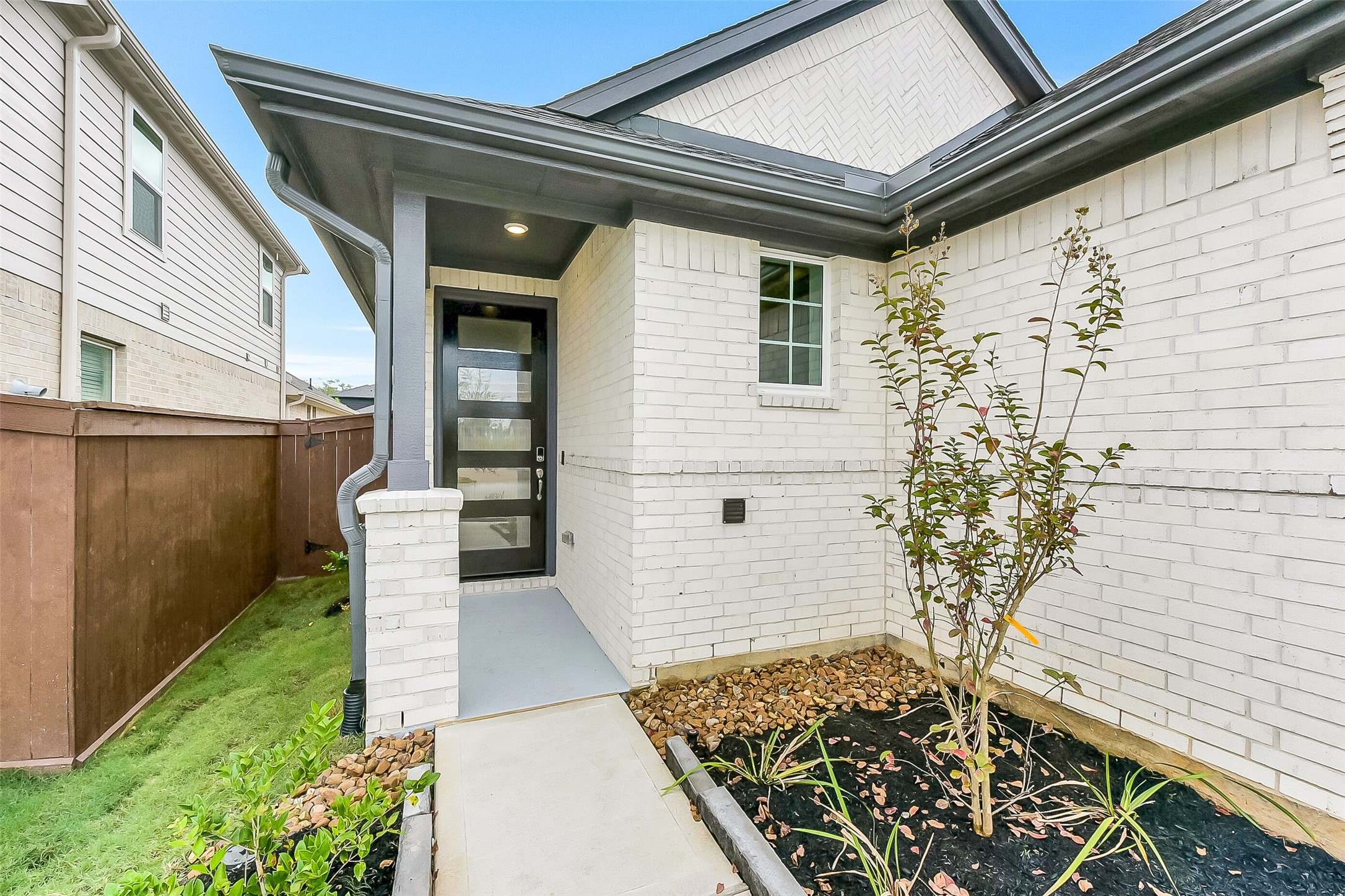 16323 Placid Stream Street Conroe, TX 77302 - Photo 3 of 36 a front view of a house with a garden