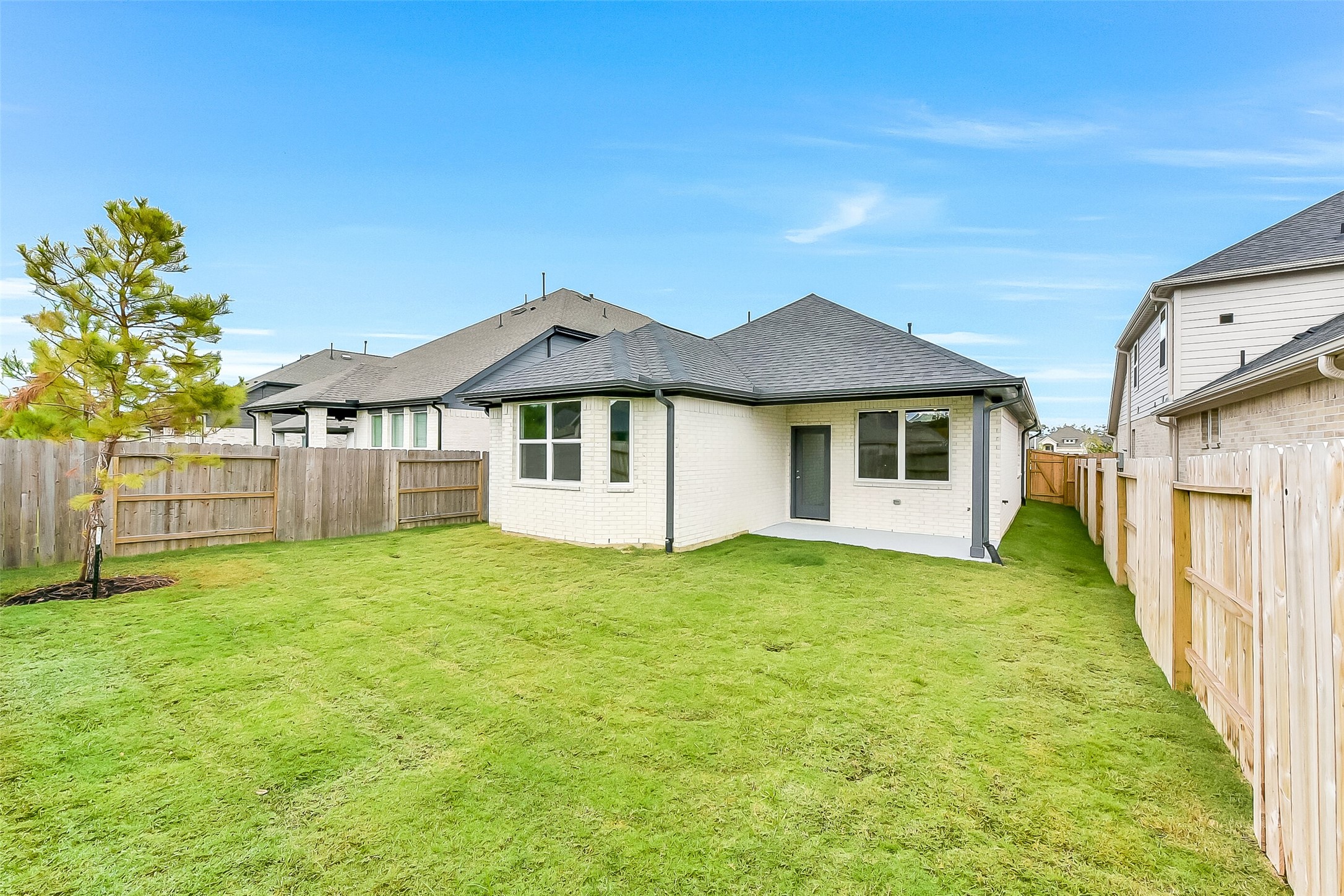 16323 Placid Stream Street Conroe, TX 77302 - Photo 33 of 36 a house with huge green field in front of it