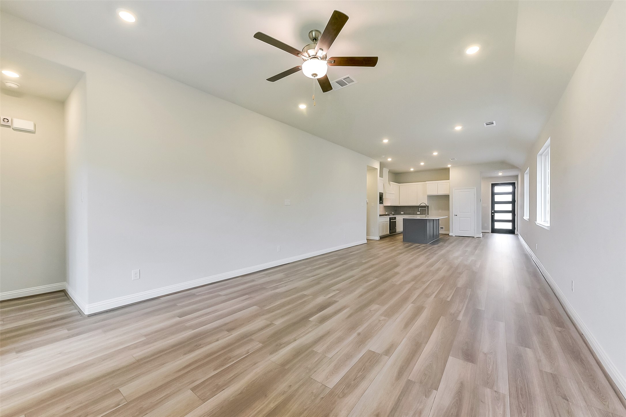 16323 Placid Stream Street Conroe, TX 77302 - Photo 7 of 36 wooden floor in an empty room with a window