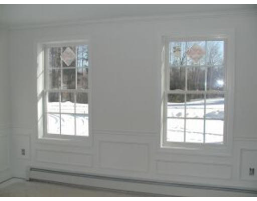 13 Taggert Circle Rindge, NH 03461 - Photo 5 of 5 an empty room with wooden floor and windows