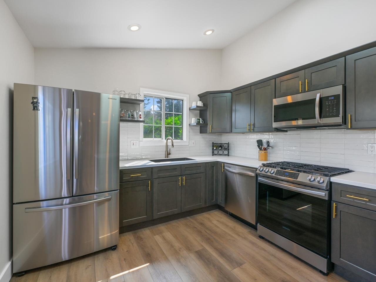 383 Explorer Court, Unit B Grand Junction, CO 81507 - Photo 15 of 40 a kitchen with stainless steel appliances granite countertop a stove top oven a sink and a refrigerator