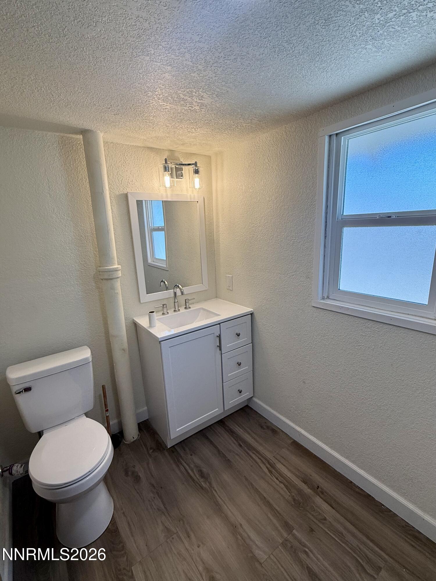 745 West Center Street Fallon, NV 89406 - Photo 10 of 31 a bathroom with a toilet sink and mirror