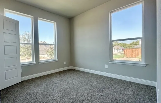 an empty room with windows and closet