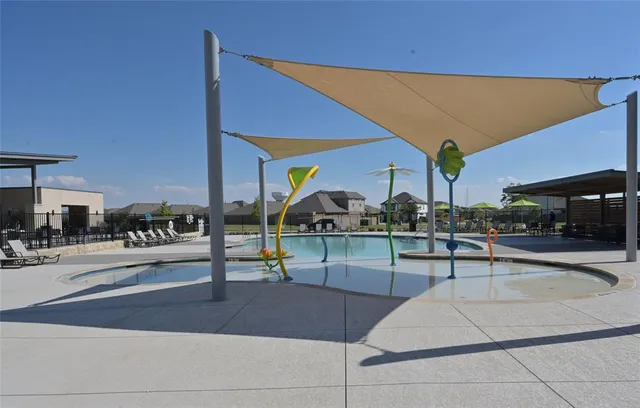 a swimming pool with outdoor seating and garden