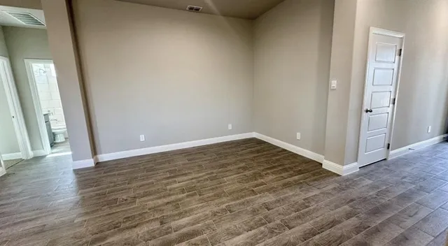 a view of walk in closet with empty racks