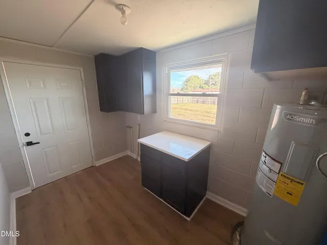 a view of room with window and wooden floor