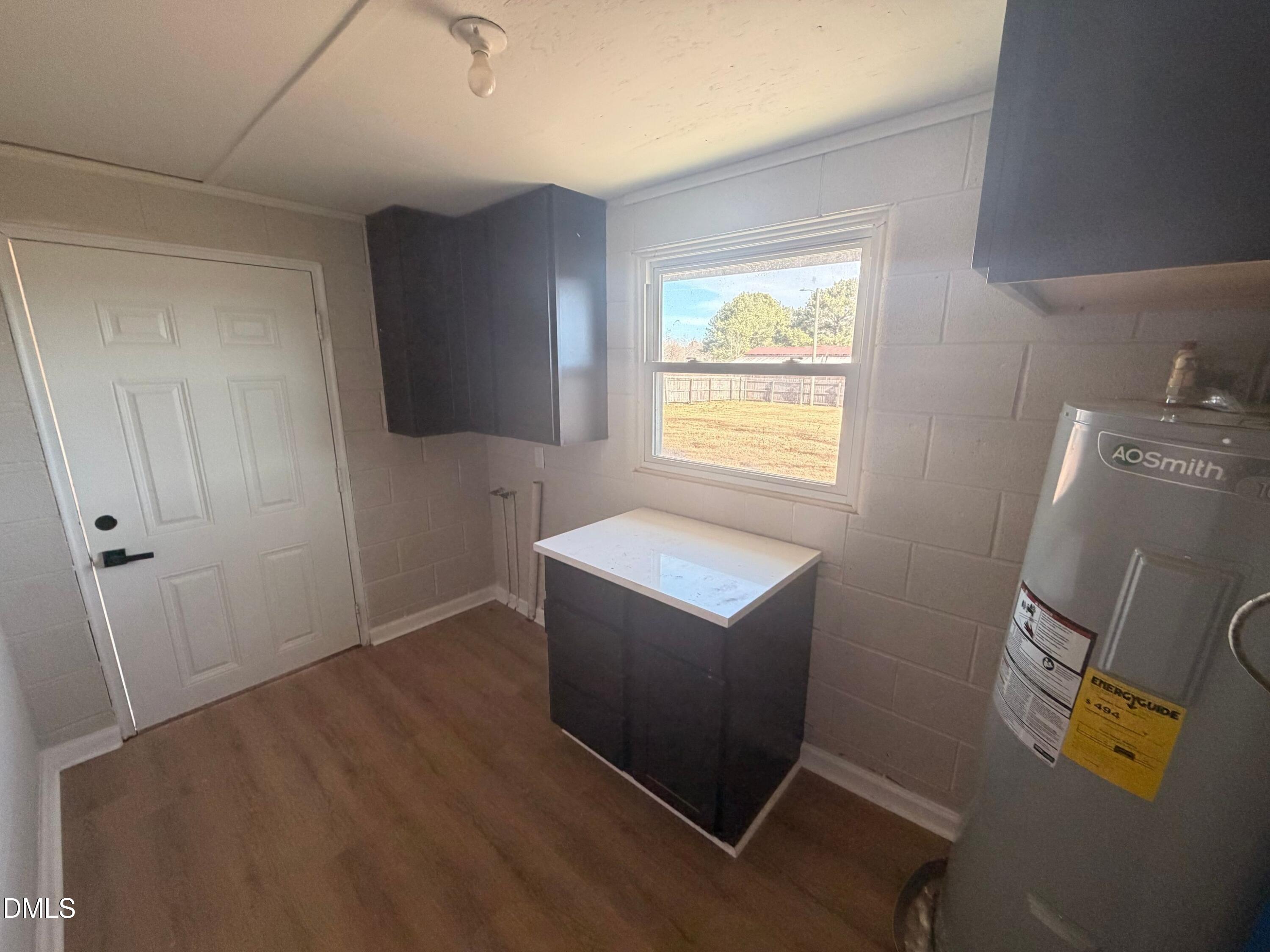 206 W Road Angier, NC 27501 - Photo 21 of 23 a view of room with window and wooden floor