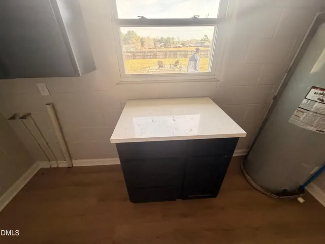 a room with wooden floor and window