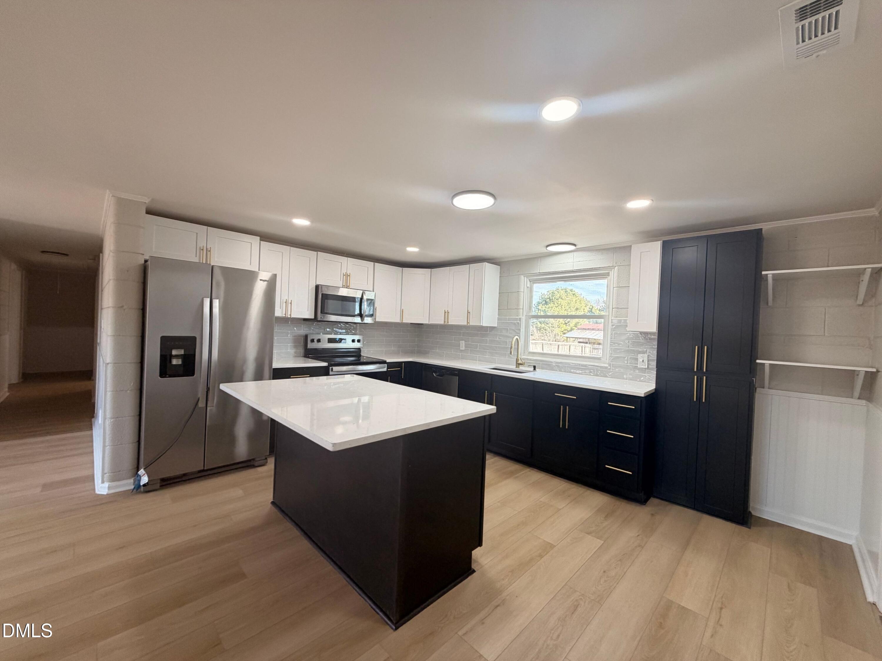 206 W Road Angier, NC 27501 - Photo 4 of 23 a kitchen with stainless steel appliances granite countertop a sink stove refrigerator and cabinets
