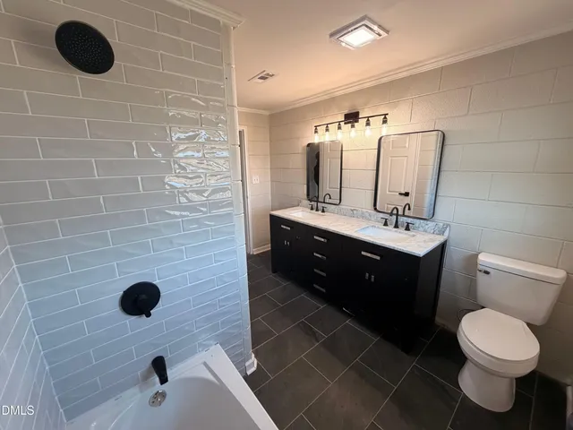 a bathroom with a sink a toilet and mirror