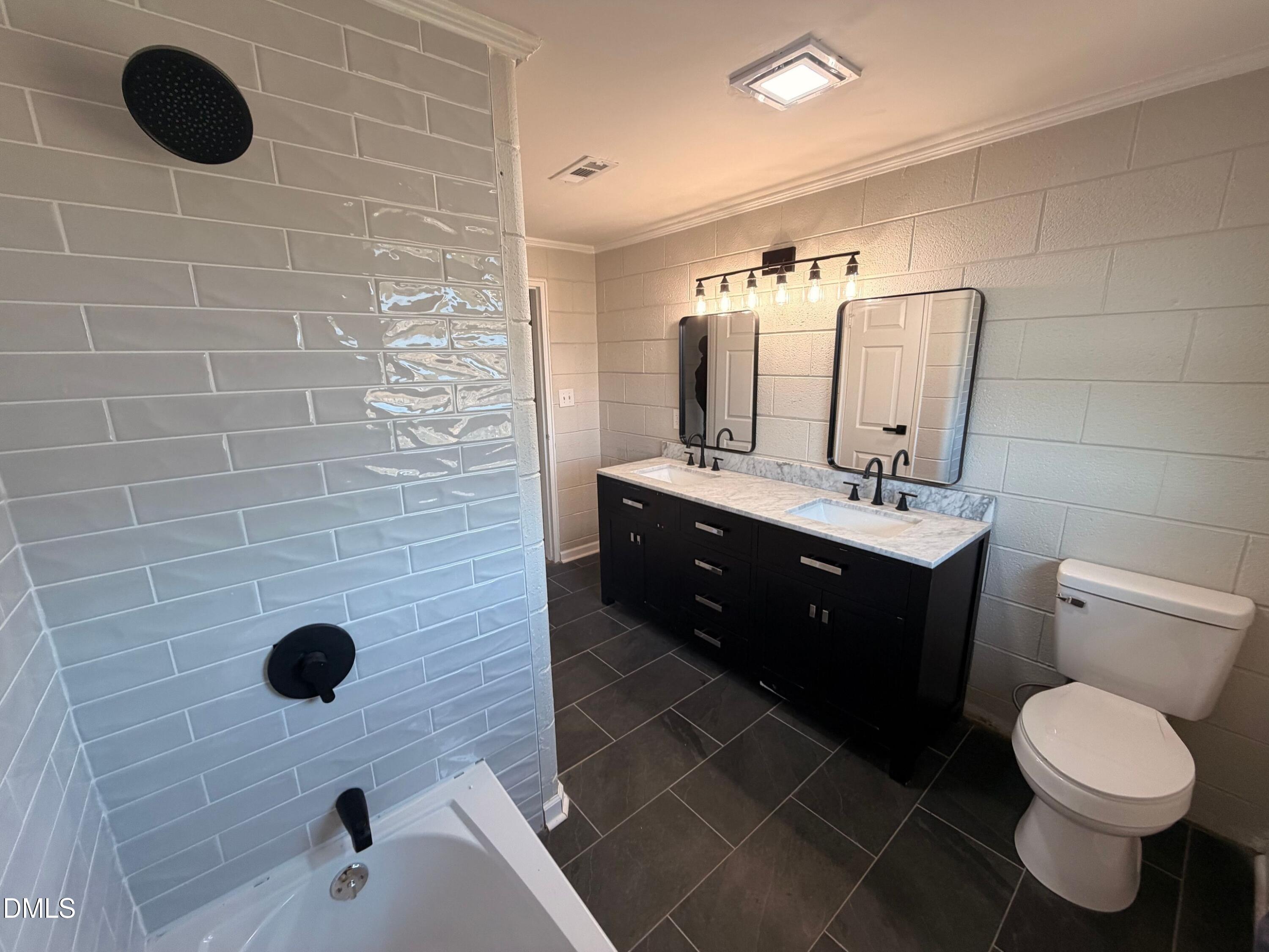 206 W Road Angier, NC 27501 - Photo 6 of 23 a bathroom with a sink a toilet and mirror