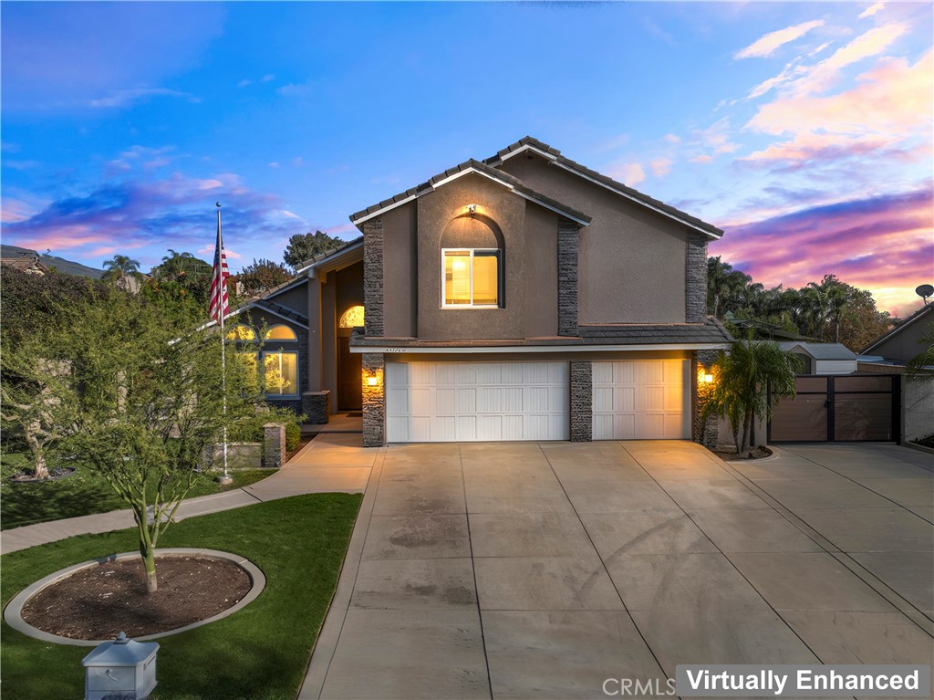 5737 Peridot Avenue Rancho Cucamonga, CA 91701 - Photo 1 of 40 a front view of a house with a yard and garage