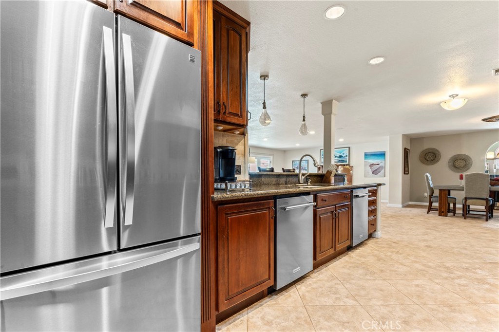 5737 Peridot Avenue Rancho Cucamonga, CA 91701 - Photo 12 of 40 a kitchen with stainless steel appliances granite countertop a refrigerator and a sink
