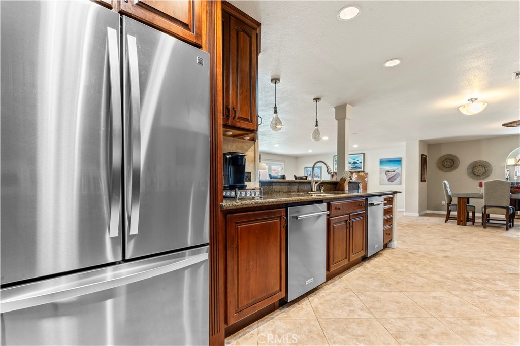 5737 Peridot Avenue Rancho Cucamonga, CA 91701 - Photo 12 of 40 a kitchen with stainless steel appliances granite countertop a refrigerator and a sink