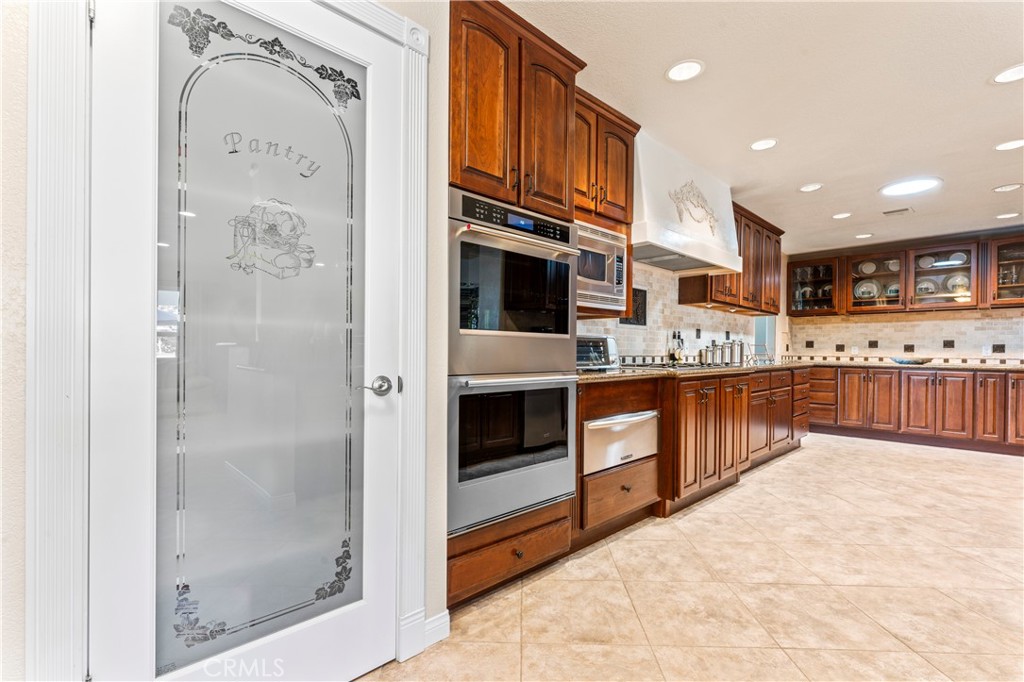 5737 Peridot Avenue Rancho Cucamonga, CA 91701 - Photo 13 of 40 a view of kitchen with stainless steel appliances granite countertop a stove and a refrigerator