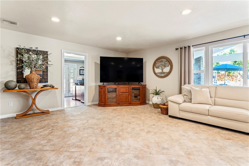 5737 Peridot Avenue Rancho Cucamonga, CA 91701 - Photo 19 of 40 a living room with furniture a large window and a flat screen tv