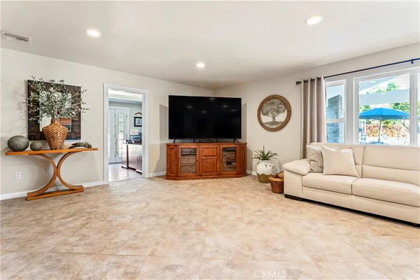 a kitchen with stainless steel appliances granite countertop a sink wooden cabinets and wooden floor