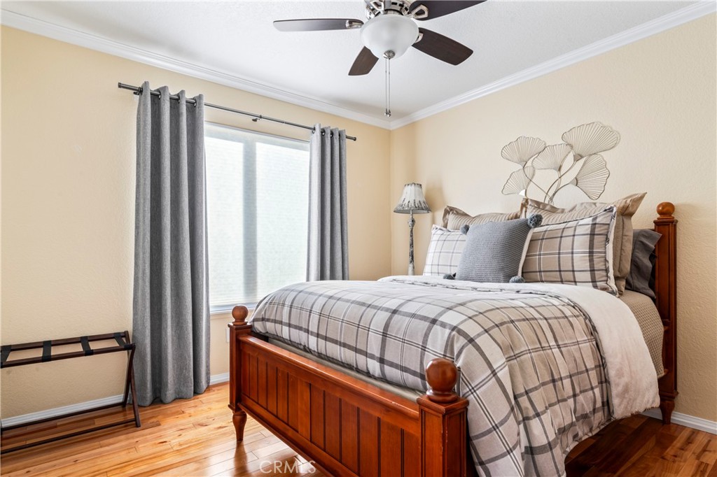 5737 Peridot Avenue Rancho Cucamonga, CA 91701 - Photo 23 of 40 a bedroom with a bed and wooden floor