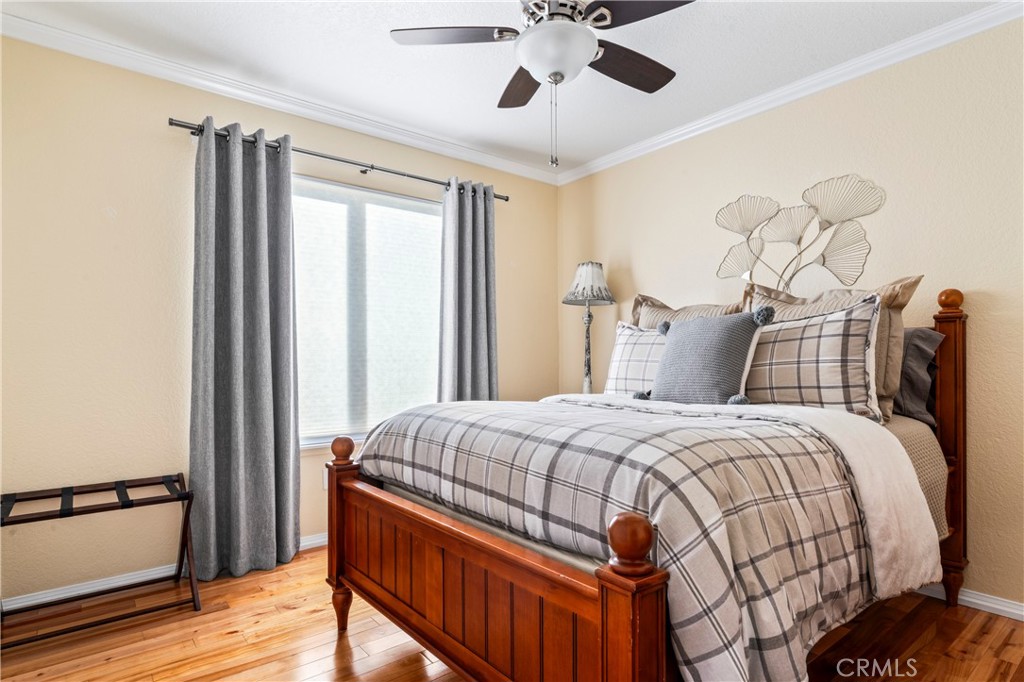 5737 Peridot Avenue Rancho Cucamonga, CA 91701 - Photo 23 of 40 a bedroom with a bed and wooden floor