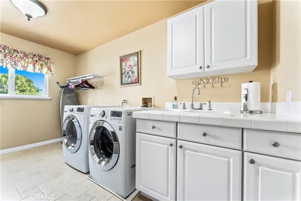 a bathroom with a granite countertop toilet sink and mirror