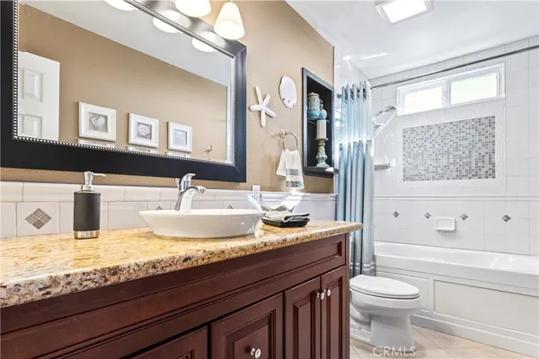a room with stainless steel appliances kitchen island a large window in it