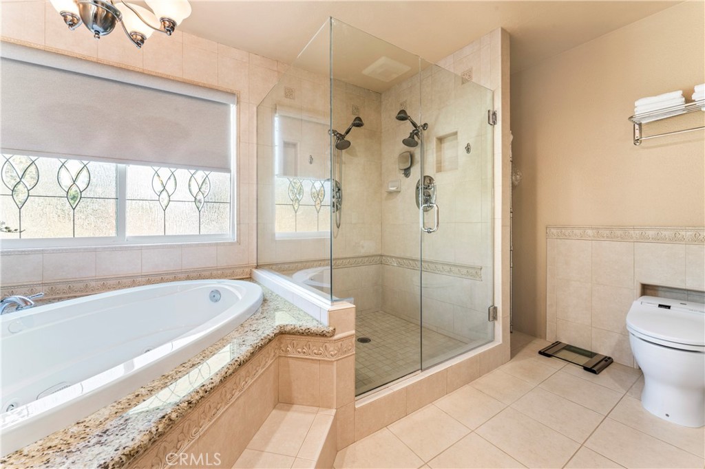 5737 Peridot Avenue Rancho Cucamonga, CA 91701 - Photo 32 of 40 a spacious bathroom with a bathtub and toilet